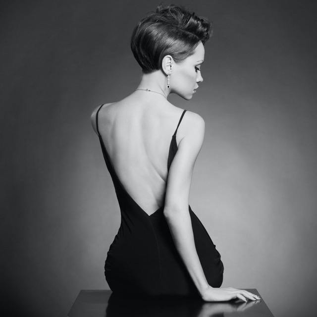 Model with jewelry, back pose in the studio.