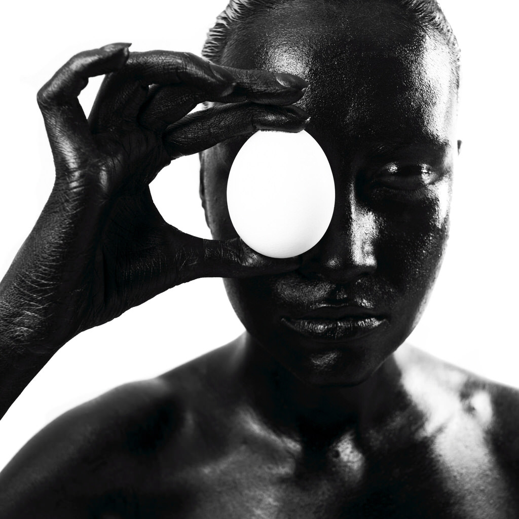 Black woman with egg. Studio photography.